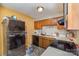 Cozy kitchen featuring wooden cabinets, appliances, and a tile floor at 2026 Harvest Ln, Charlotte, NC 28210