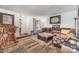 View of the living room featuring wood-look flooring, a brown sofa with throw pillows, and an interior door at 2026 Harvest Ln, Charlotte, NC 28210