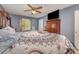 Comfortable bedroom with carpeted floors, a ceiling fan, TV, and a view to the outdoors at 2026 Harvest Ln, Charlotte, NC 28210