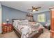 Cozy primary bedroom with a ceiling fan, and carpeted floors, and wooden furniture at 2026 Harvest Ln, Charlotte, NC 28210