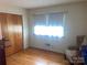 Bedroom showcasing hardwood floors, a bright window, and closet space at 205 Rudolph Rd, Salisbury, NC 28146
