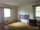 A bedroom featuring wood headboard, window, and carpeted floors at 205 Rudolph Rd, Salisbury, NC 28146