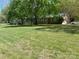 Large yard with mature trees surrounding a brick home with ample windows and attached garage at 205 Rudolph Rd, Salisbury, NC 28146