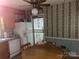 Charming kitchen with unique wallpaper, wood cabinets, and a cozy breakfast nook at 205 Rudolph Rd, Salisbury, NC 28146