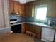 An efficient kitchen features appliances, a double basin sink, and ample cabinet space at 205 Rudolph Rd, Salisbury, NC 28146
