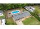 Aerial view of property with a pool, large backyard, detached garage and mature trees at 213 Lakeview Dr, Harrisburg, NC 28075
