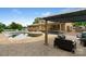 Spacious backyard featuring covered deck and inground pool at 213 Lakeview Dr, Harrisburg, NC 28075