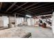 Spacious unfinished basement featuring exposed ductwork, concrete floor, and staircase at 213 Lakeview Dr, Harrisburg, NC 28075