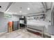 Basement features tile floors, drop ceiling, metal shelving and adjacent gray wall at 213 Lakeview Dr, Harrisburg, NC 28075