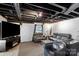 A cozy basement with a TV area and comfortable seating offers a relaxing retreat at 213 Lakeview Dr, Harrisburg, NC 28075