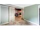 Open basement room featuring a view of another room with gray walls and double doors at 213 Lakeview Dr, Harrisburg, NC 28075
