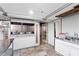 Open basement area features access to another room, tile flooring, and lighting at 213 Lakeview Dr, Harrisburg, NC 28075