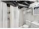 A functional bathroom features a standing shower, vanity and toilet, plus a convenient washer/dryer at 213 Lakeview Dr, Harrisburg, NC 28075