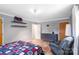 Relaxing bedroom with wood floors, neutral walls, floating shelves, and comfy chair at 213 Lakeview Dr, Harrisburg, NC 28075