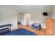 This bedroom features sleek hardwood floors, mirrored closet doors, and a compact layout at 213 Lakeview Dr, Harrisburg, NC 28075