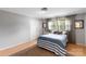 Neutral bedroom with hardwood floors, double closet, and ample natural light at 213 Lakeview Dr, Harrisburg, NC 28075
