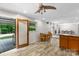 Open dining area with wood floors features a table, fan, and door to outdoor pool at 213 Lakeview Dr, Harrisburg, NC 28075