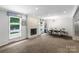 Bright dining room featuring a contemporary chandelier, fireplace, and wainscoting at 213 Lakeview Dr, Harrisburg, NC 28075
