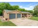 Brick ranch-style home with two-car garage and well-manicured landscaping on a sunny day at 213 Lakeview Dr, Harrisburg, NC 28075