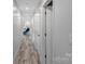 An airy hallway with neutral walls provides seamless transition between living spaces within the home at 213 Lakeview Dr, Harrisburg, NC 28075