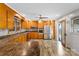 Warm kitchen with honey oak cabinets, stainless steel appliances, and modern ceiling fan at 213 Lakeview Dr, Harrisburg, NC 28075
