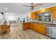 Open kitchen with honey oak cabinets, stainless steel appliances, and an open view into the dining area at 213 Lakeview Dr, Harrisburg, NC 28075