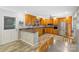 Warm kitchen featuring honey oak cabinets, stainless steel appliances, and stylish backsplash at 213 Lakeview Dr, Harrisburg, NC 28075