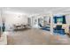 Open living and dining room features textured wall, modern lighting, and neutral decor at 213 Lakeview Dr, Harrisburg, NC 28075