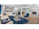 Bright living room with fireplace, white leather sofas and blue accents, seamlessly connecting to the dining area at 213 Lakeview Dr, Harrisburg, NC 28075
