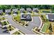 View shows community clubhouse, bocce court, parking, and some homes at 213 Warbler Dr, Monroe, NC 28110