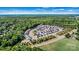 Panoramic aerial perspective of housing development nestled beside wooded area and roadway at 213 Warbler Dr, Monroe, NC 28110