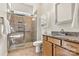 Well-lit bathroom with a tiled shower, granite countertop vanity, and ample storage space at 213 Warbler Dr, Monroe, NC 28110