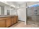 Beautiful bathroom with a modern tiled shower, glass door, and double sink vanity at 213 Warbler Dr, Monroe, NC 28110