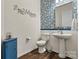 Elegant half bathroom with designer wallpaper, pedestal sink, and stylish fixtures at 213 Warbler Dr, Monroe, NC 28110