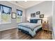 Comfortable bedroom with a cozy bed, hardwood flooring, and windows for natural light at 213 Warbler Dr, Monroe, NC 28110