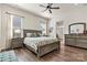 Spacious bedroom with a dresser, hardwood flooring, and windows for natural light at 213 Warbler Dr, Monroe, NC 28110