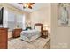 Inviting bedroom with a ceiling fan, natural light, and wicker furniture for a relaxed atmosphere at 213 Warbler Dr, Monroe, NC 28110