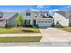 Charming home with a two-car garage, neat landscaping and an American flag displayed in the front yard at 213 Warbler Dr, Monroe, NC 28110
