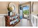 Beautiful foyer with hardwood floors, a round mirror, console table, and an open front door at 213 Warbler Dr, Monroe, NC 28110