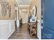 Inviting foyer with dark wood floors, neutral walls, white trim, and a console table at 213 Warbler Dr, Monroe, NC 28110