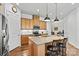 A spacious kitchen features an island with bar stool seating, stainless appliances, and tile backsplash at 213 Warbler Dr, Monroe, NC 28110