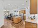 This open-concept kitchen features a spacious island, stainless steel appliances, and hardwood floors at 213 Warbler Dr, Monroe, NC 28110