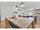 Granite countertops and a stainless dishwasher accent this stylish kitchen and eat-in breakfast nook at 213 Warbler Dr, Monroe, NC 28110