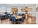 This open-concept eat-in kitchen includes stainless appliances, pendant lighting, and an eat-in dining area at 213 Warbler Dr, Monroe, NC 28110