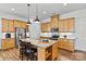 The modern kitchen is fitted with stainless appliances, granite countertops, and a central island with seating at 213 Warbler Dr, Monroe, NC 28110