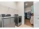 Efficient laundry room with modern washer and dryer, and a walk-in closet for easy storage at 213 Warbler Dr, Monroe, NC 28110