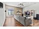 Comfortable open-concept living room including ceiling fan, hardwood floors, and an adjacent dining area at 213 Warbler Dr, Monroe, NC 28110