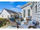 Charming patio featuring comfortable wicker furniture, a cozy fire pit, and neighborhood views at 213 Warbler Dr, Monroe, NC 28110