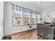 Bright sun room featuring a large window, hardwood flooring, and a comfortable sofa at 213 Warbler Dr, Monroe, NC 28110
