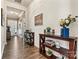 Inviting foyer with a decorative console table, hardwood floors, and crown molding at 213 Warbler Dr, Wesley Chapel, NC 28110